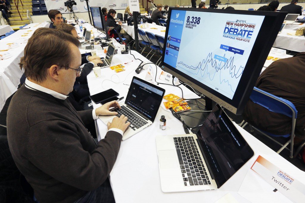 Twitter employee Adam Sharp monitors data from the service during the Democratic presidential primary debate, Saturday, Dec. 19, 2015, at Saint Anselm College in Manchester, N.H. (AP Photo/Michael Dwyer)