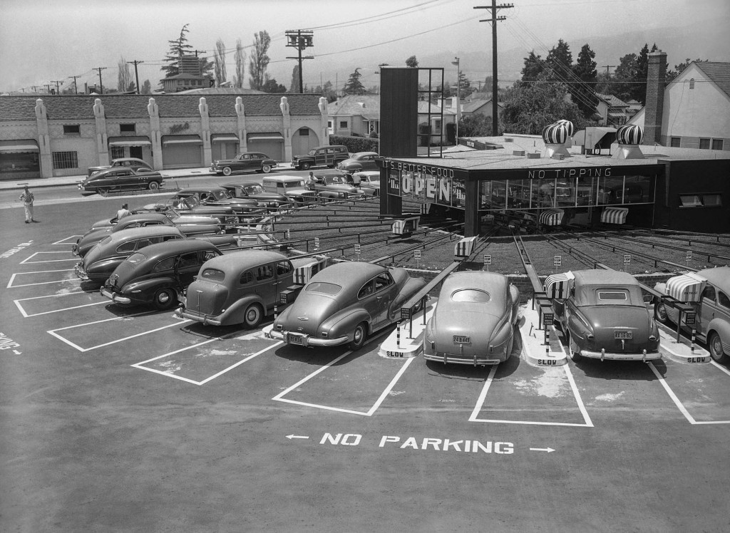 Hungry motorists are served by electrically controlled cable car at The Track, an advanced type of drive-in restaurant in Los Angeles in 1949. (© AP Images)