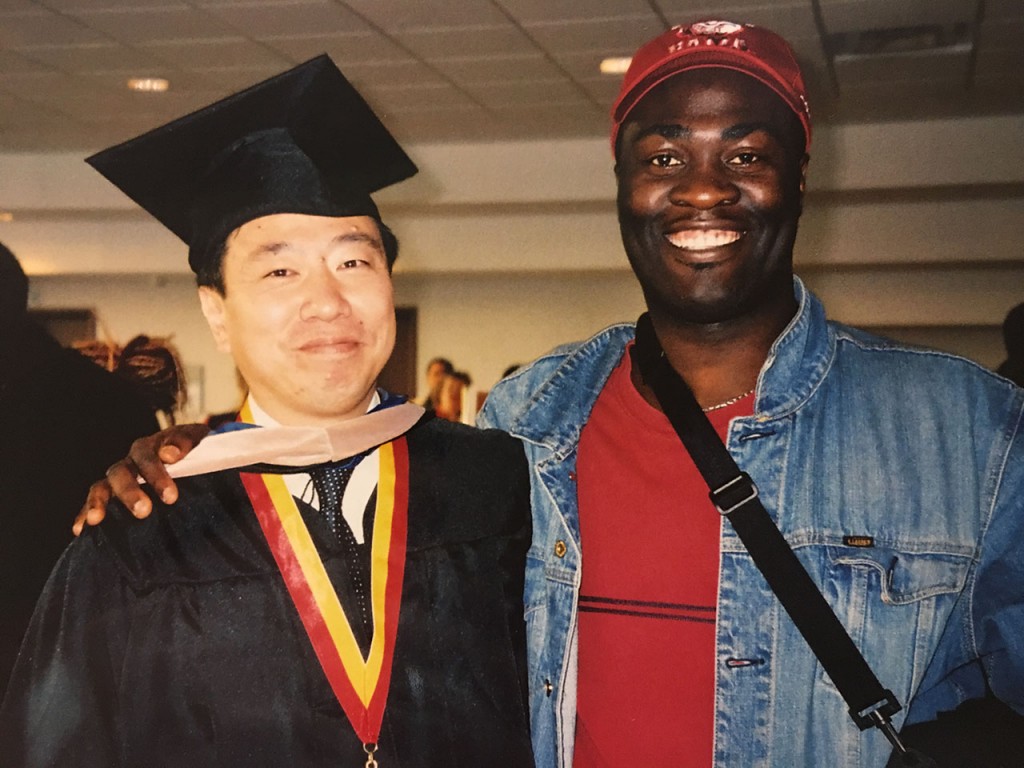 Suga with a friend at his graduation from the MBA program at Georgia State University.
