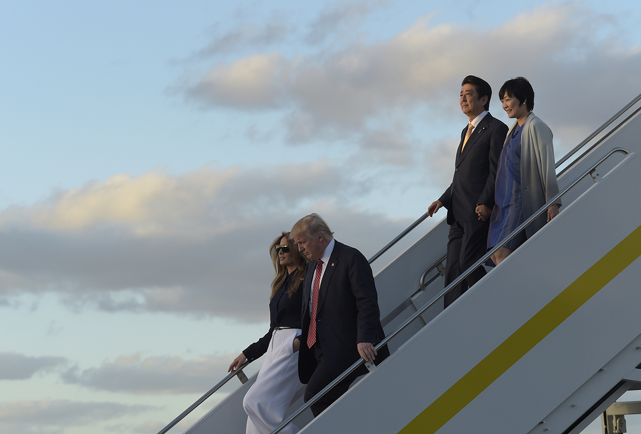 President Donald Trump and first lady Melania Trump, left, and Japanese Prime Minister Shinzo Abe and his wife Akie Abe, right, walk down the steps of Air Force One at West Palm Beach International Airport in West Palm Beach, Fla., Friday, Feb. 10, 2017. The Trumps are hosting the Abes at their Mar-a-Lago estate in Palm Beach for the weekend. (AP Photo/Susan Walsh)