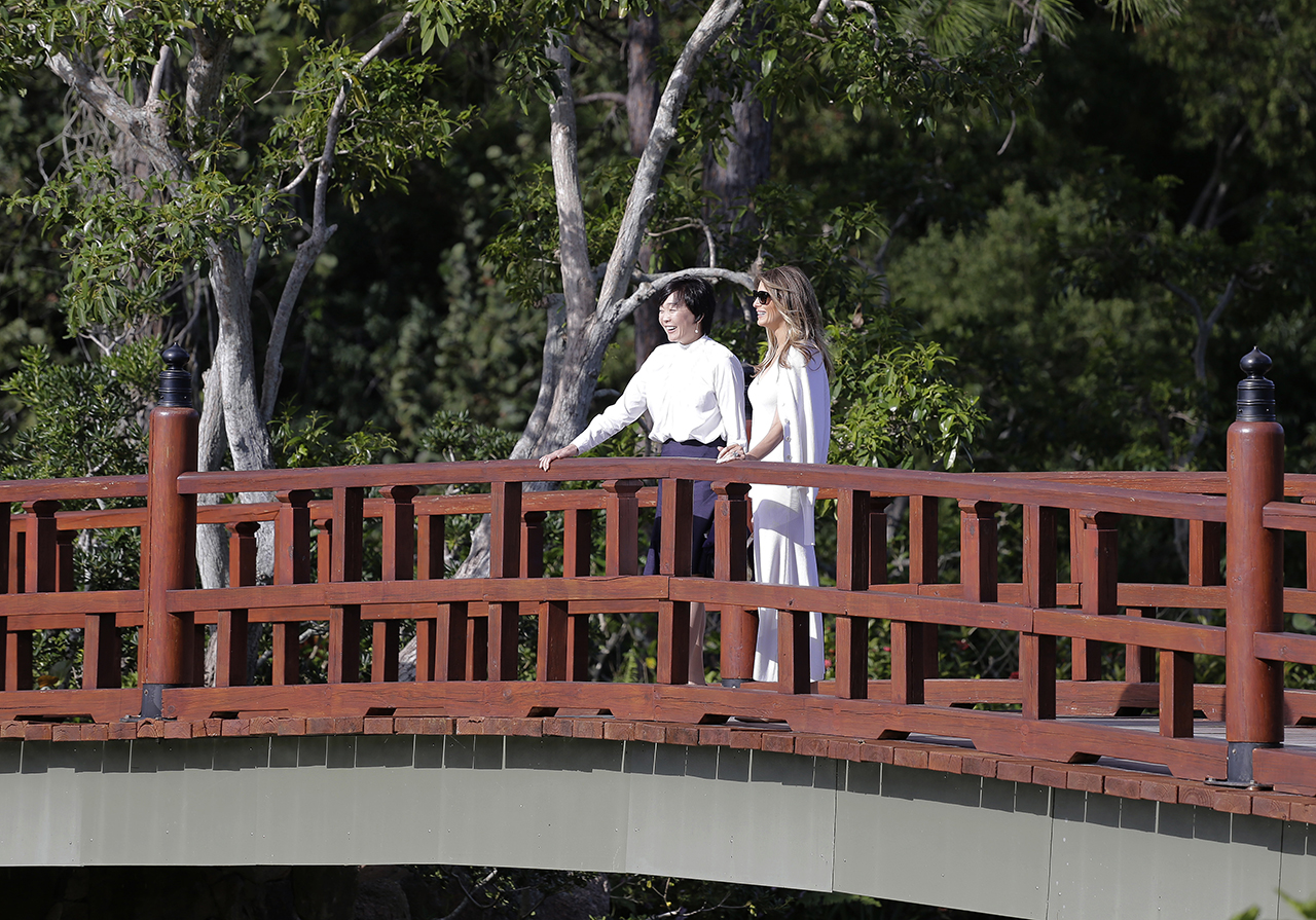 Akie Abe, wife of Japanese Prime Minister Shinzo Abe, left, and first lady Melania Trump tour Morikami Meseum and Japanese Gardens in Delray Beach, Fla., on Saturday, Feb. 11, 2017. (AP Photo/Terry Renna)