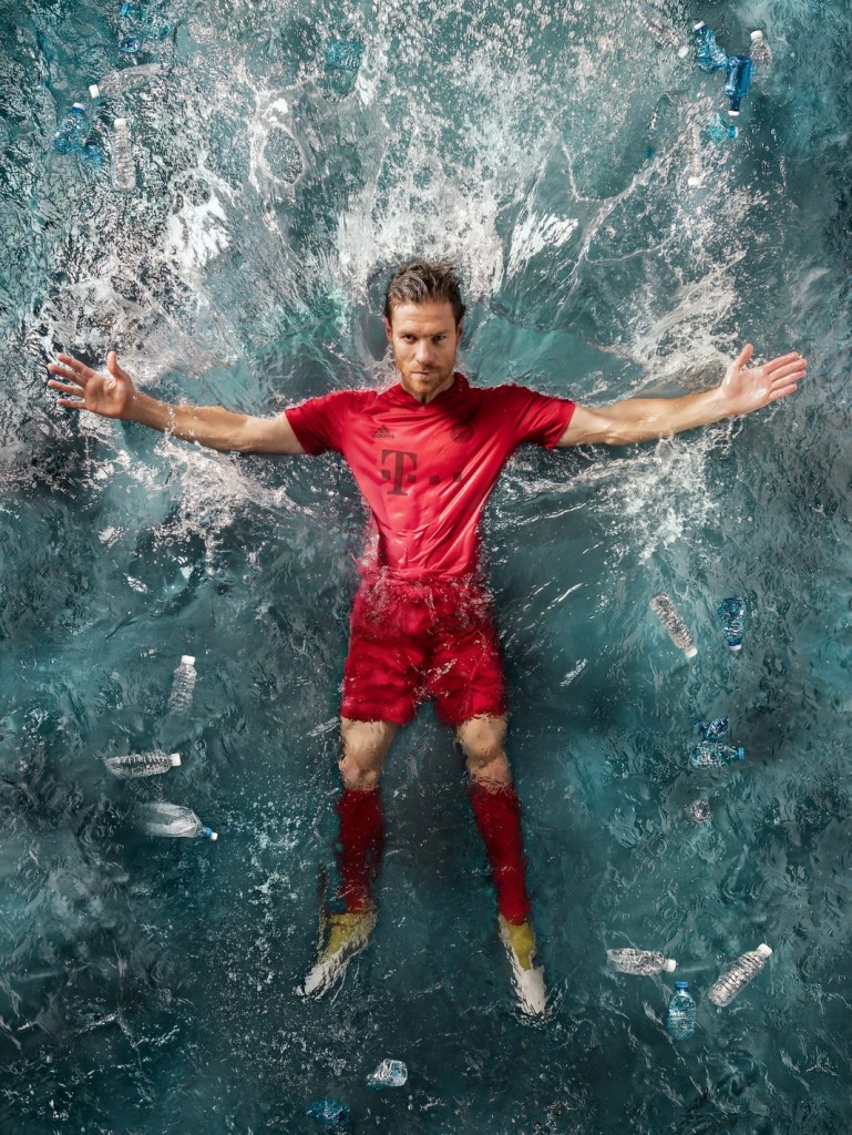Bayern Munich star Xabi Alonso shows off a new jersey made entirely of recycled ocean debris. (Courtesy photo)