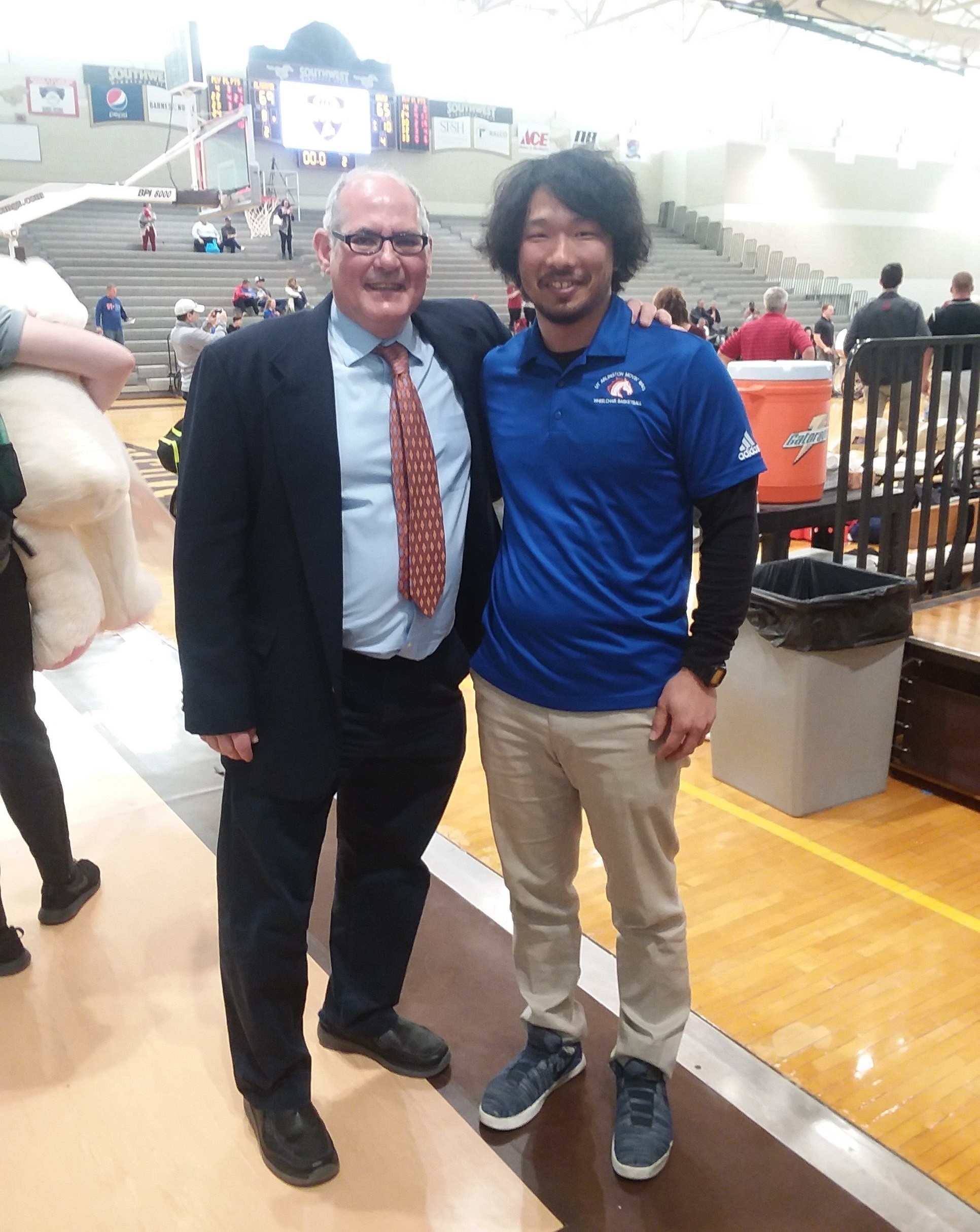 With Doug Garner, coach of the UTA wheelchair basketball team. Garner inspired Saito to study abroad.