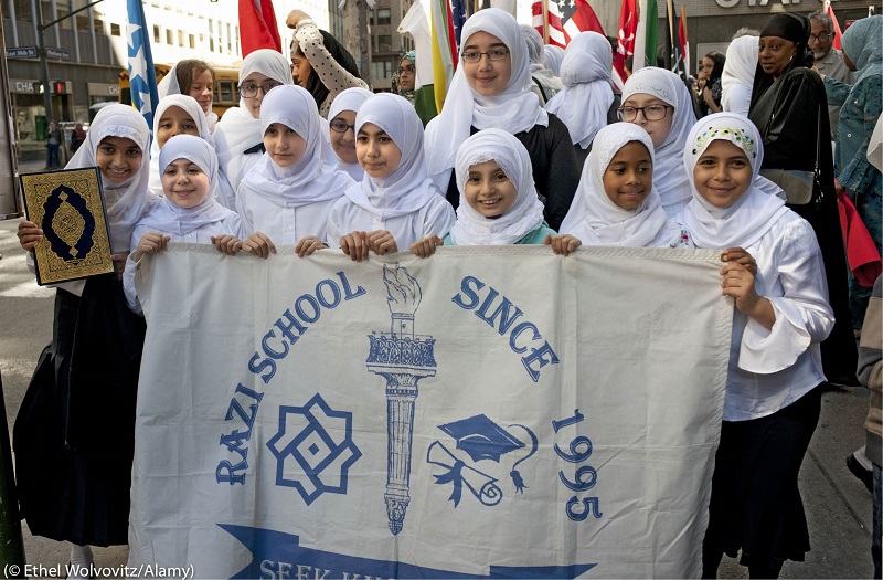 Girls from the Razi School in Queens, New York City, attend a parade. The school offers classes from pre-school through secondary school. (© Ethel Wolvovitz/Alamy)