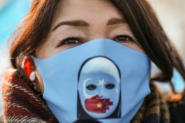 A Uyghur woman protests the People’s Republic of China’s abuse of Uyghurs in Xinjiang during a March 25 protest in Istanbul. (© Emrah Gurel/AP Images)