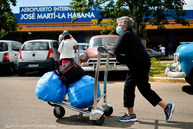 A Cuban American arrives with luggage as she leaves Havana’s José Martí International Airport November 20, 2020. Many Cuban Americans bring supplies for their families in Cuba. (© Yamil Lage/AFP/Getty Images)