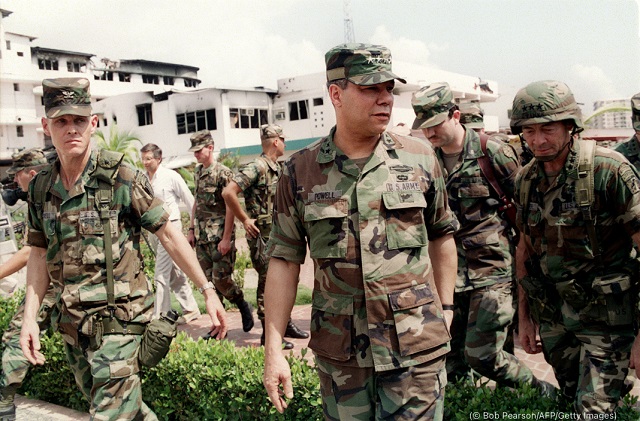General Colin Powell (center), then chairman of the Joint Chiefs of Staff, reviews U.S. troops in Panama City January 5, 1990. (© Bob Pearson/AFP/Getty Images)