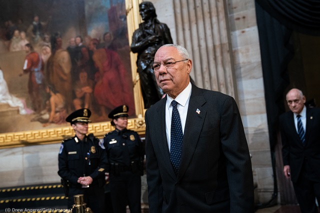 Former Secretary of State Colin Powell pays respects to former President George H.W. Bush as he lies in state at the U.S. Capitol in Washington December 4, 2018. (© Drew Angerer/Getty Images)