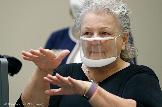 Interpreter Sandra Hester wears a see-through face mask so that the hard of hearing can see her facial expressions as she signs at the University of Mississippi Medical Center in July 2020 in Jackson, Mississippi. (© Rogelio V. Solis/AP Images)