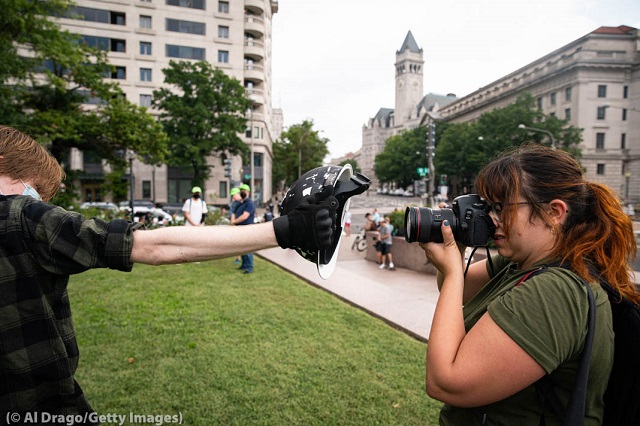 U.S. media cover protests around the world, such as this one in Washington in 2021. The First Amendment protects reporters in the U.S. (© Al Drago/Getty Images)