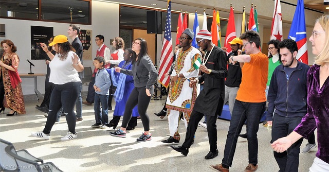 American University students and staff dance at an International Student & Scholar Services cultural festival. (© American University)