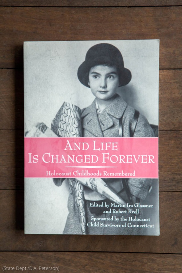 A photo of Susan Benda’s mother, Eva, appears on the cover of a book detailing children’s experiences during the Holocaust. Benda’s chapter is entitled “From Prague to Theresienstadt and Back.” (State Dept./D.A. Peterson)