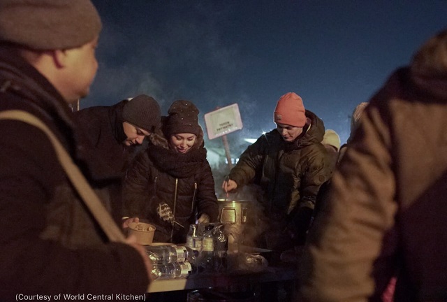 Recent arrivals to the Poland/Ukraine border enjoy hot soup and tea from World Central Kitchen February 26. (Courtesy of World Central Kitchen)