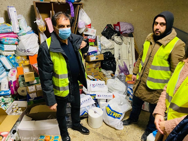 Supplies for Ukrainian refugees in Moldova surround Mehmet Demir, left, of Zakat Foundation. (Courtesy of Zakat Foundation)