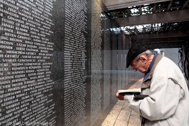 Arnold Meyer prays at the Memorial Wall in Miami Beach, Florida, for his parents and sister, who died in the Holocaust. (© Alan Diaz/AP Images)