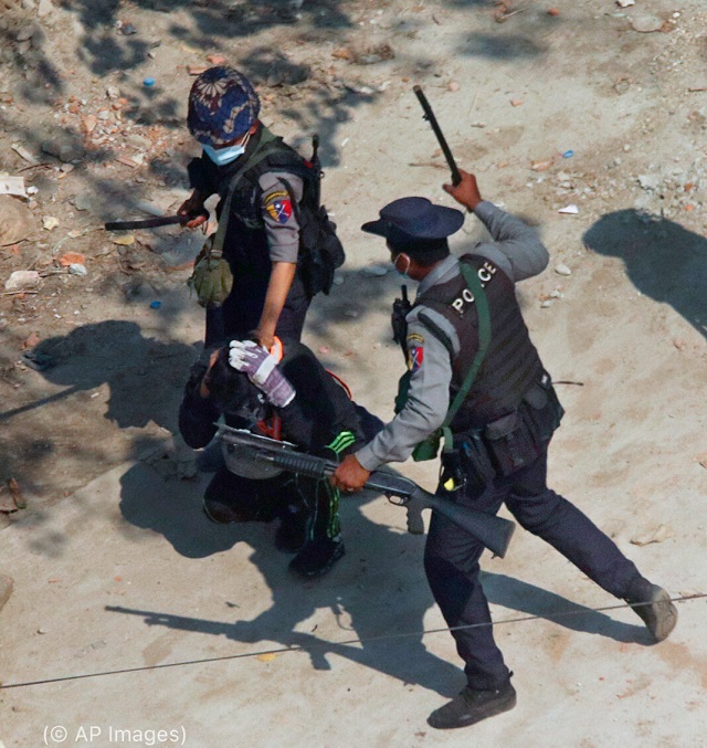 Police officers beat a protester March 6, 2021, outside Rangoon, Burma. The Burmese military regime has killed or detained thousands of protesters since a February 2021 military coup. (© AP Images)