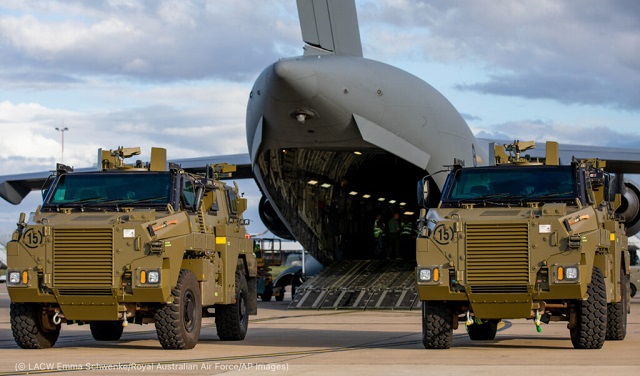 Two armored vehicles await shipment to Ukraine at Royal Australian Air Force Base Amberley in Australia April 7. (© LACW Emma Schwenke/Royal Australian Air Force/AP Images)