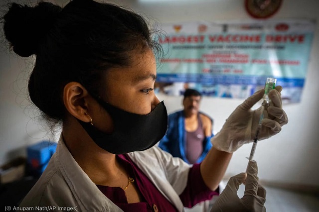 The United States and India have each moved quickly to supply the other with health care supplies during the COVID-19 pandemic. A nurse prepares to administer a COVID-19 vaccine dose in Gauhati, India, April 10. (© Anupam Nath/AP Images)