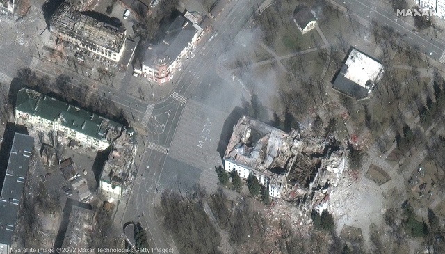 Maxar satellite imagery from March 29 shows an image of the extensive damage to a theater in Mariupol, with the word “children” written so it can be seen from the air, and surrounding civilian buildings in Mariupol, Ukraine. (Satellite image ©2022 Maxar Technologies/Getty Images)