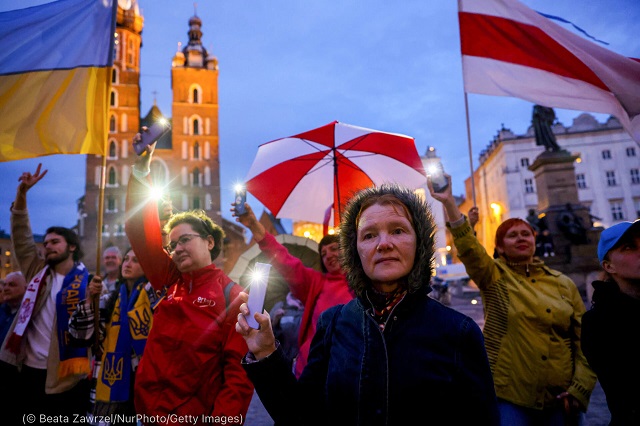 People attend a charity concert at the Main Square in Krakow, Poland, in May. The event was a gesture of gratitude of Ukrainian citizens living in Krakow to Poles for their help and support following Russia’s invasion. (© Beata Zawrzel/NurPhoto/Getty Images)