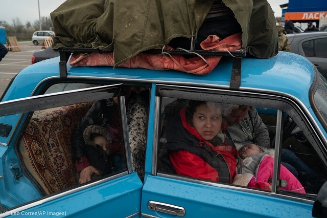 Internally displaced Ukrainian civilians like these, coming from Russia-controlled Mariupol, must wait days to pass through filtration checkpoints in hopes of reaching Ukraine-controlled Zaporizhzhia. (© Leo Correa/AP Images)