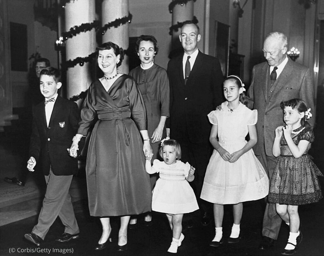 President Dwight Eisenhower and Mamie Eisenhower gather with family members at the White House on Christmas Day 1957. (© Corbis/Getty Images)