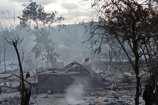 2021年6月16日、軍が村を焼いたと住民が証言した後のビルマ中部のキンマ村。家が煙に包まれている (© AP)