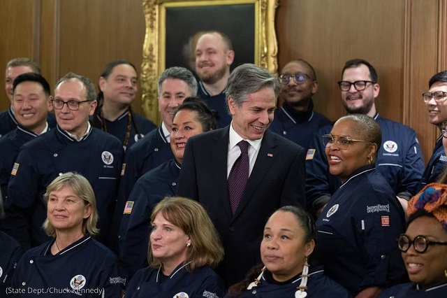 Secretary of State Antony Blinken huddles with chefs and other members of the American Culinary Corps, such as Tanya Holland on his left, during the Diplomatic Culinary Partnership’s relaunch in the State Department’s Benjamin Franklin Room. (State Dept./Chuck Kennedy)